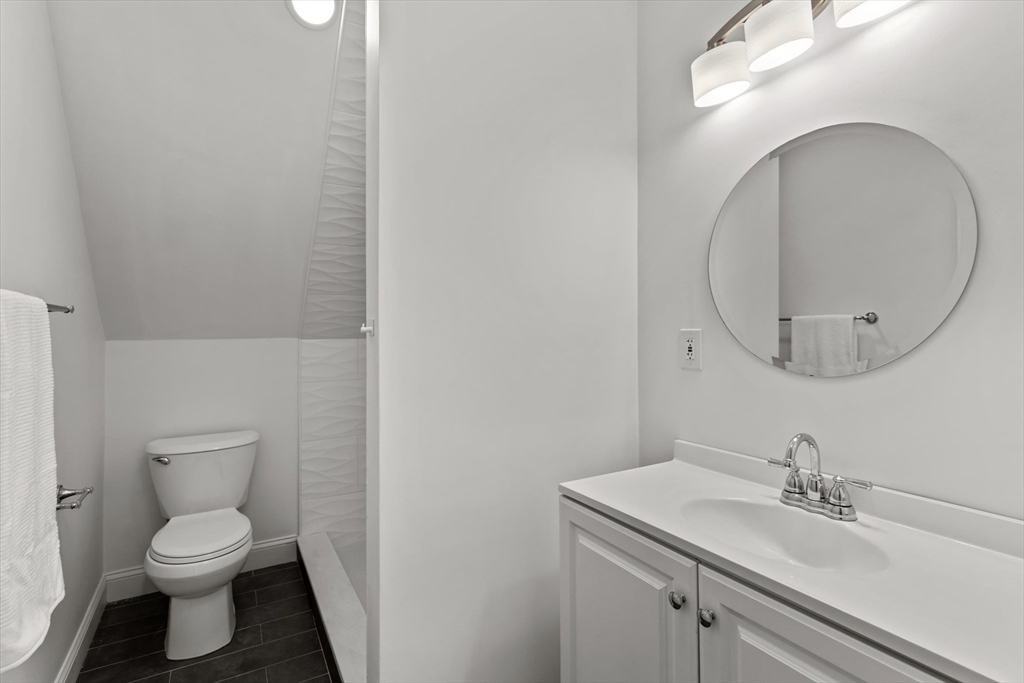 98 Flint Street, Unit 2 Somerville, MA 02145 - Photo 29 of 40 a bathroom with a toilet sink and mirror