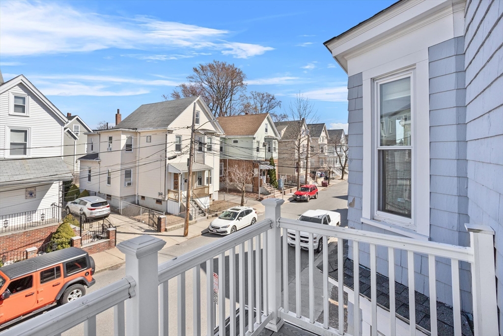 98 Flint Street, Unit 2 Somerville, MA 02145 - Photo 34 of 40 a view of a chairs and table in a balcony