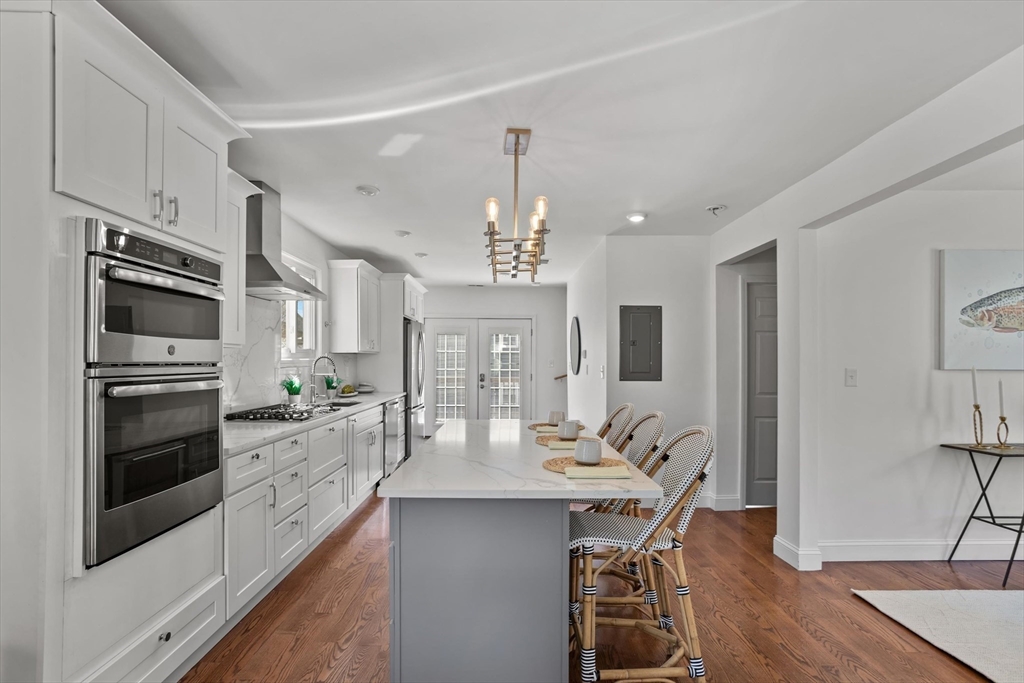 98 Flint Street, Unit 2 Somerville, MA 02145 - Photo 4 of 40 a kitchen with a center island appliances and cabinets
