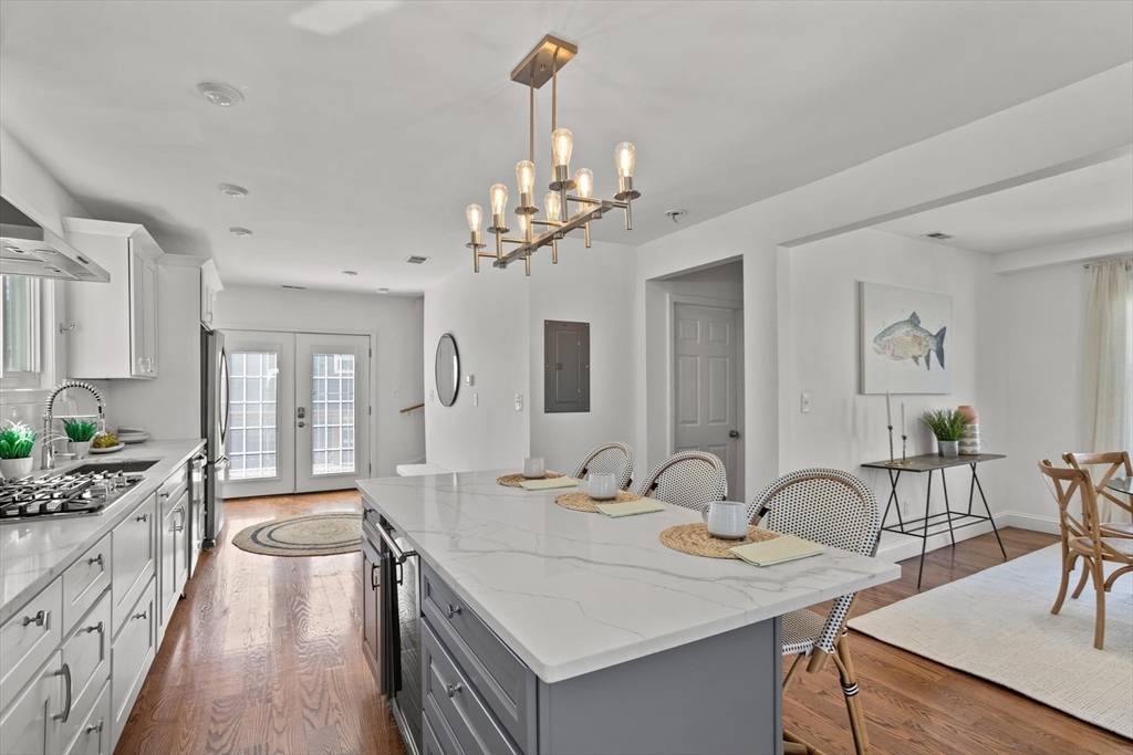 98 Flint Street, Unit 2 Somerville, MA 02145 - Photo 6 of 40 a very nice looking dining room with kitchen island stainless steel appliances a table and chairs