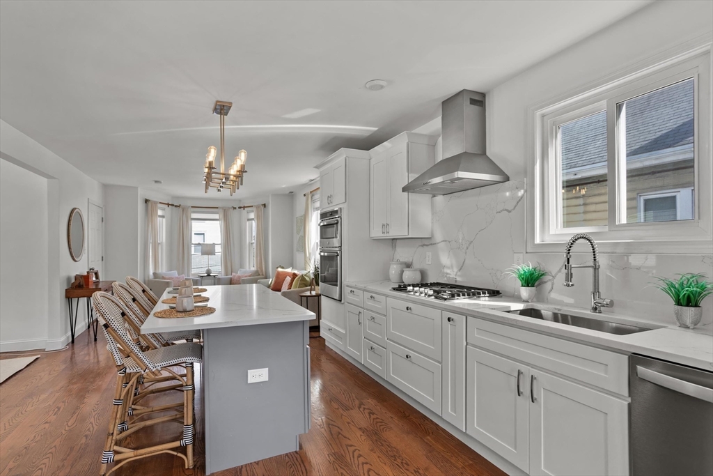 98 Flint Street, Unit 2 Somerville, MA 02145 - Photo 8 of 40 a kitchen with a counter space a sink appliances and cabinets