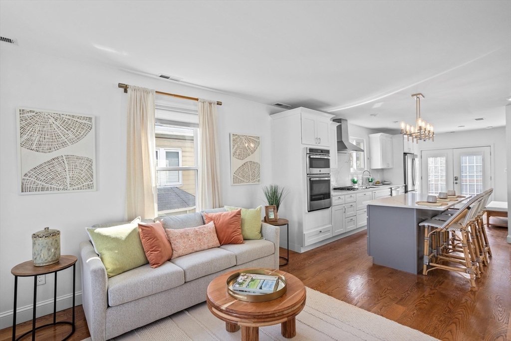 98 Flint Street, Unit 2 Somerville, MA 02145 - Photo 9 of 40 a living room with furniture and wooden floor