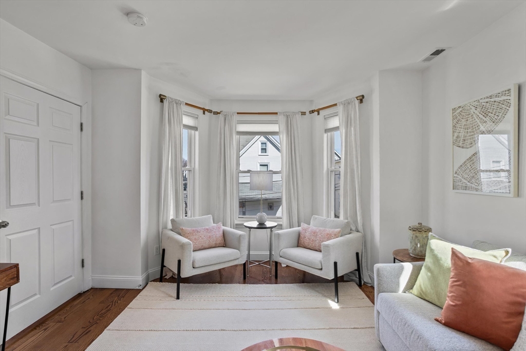 98 Flint Street, Unit 2 Somerville, MA 02145 - Photo 10 of 40 a living room with furniture and a large window