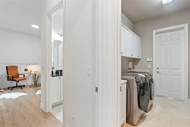 a utility room with sink dryer and washer