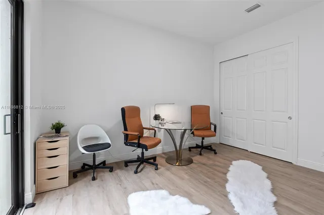 a view of a room with wooden floor