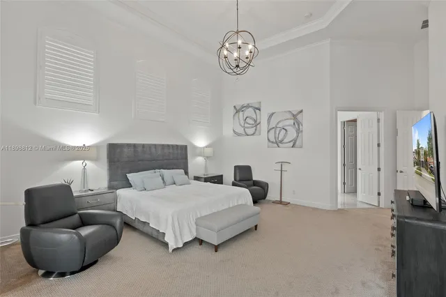 a bedroom with a bed two lamps and a large window