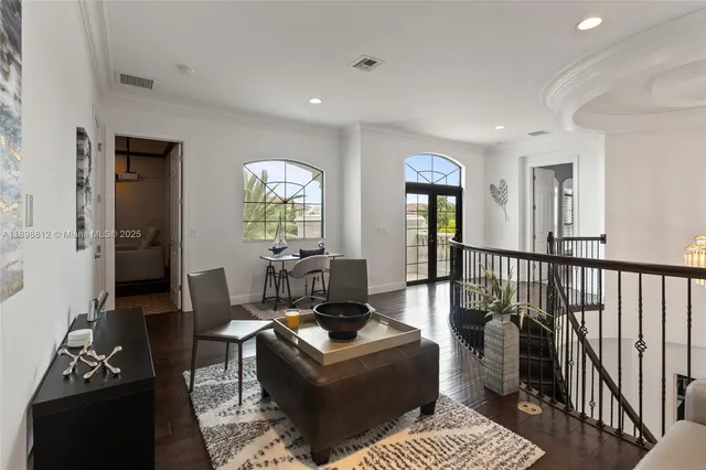 a view of a patio with couches and a table and chairs with garden view