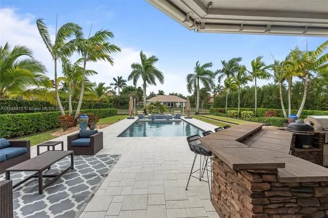 an aerial view of residential houses with outdoor space and swimming pool