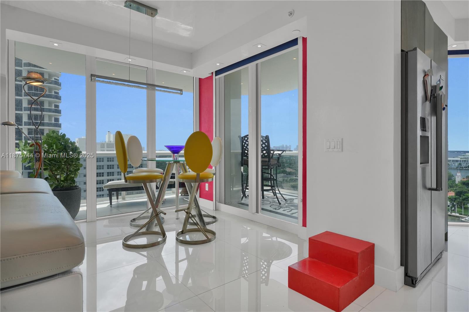 4779 Collins Avenue, Unit 1805 Miami Beach, FL 33140 - Photo 12 of 39 a view of a livingroom with furniture and a floor to ceiling window