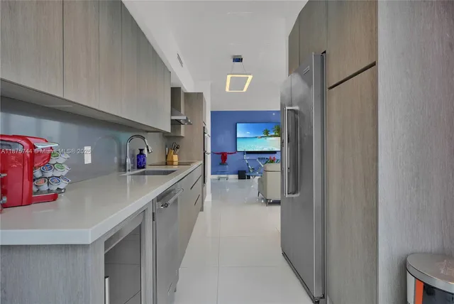 a kitchen view with stainless steel appliances granite countertop a stove and a refrigerator