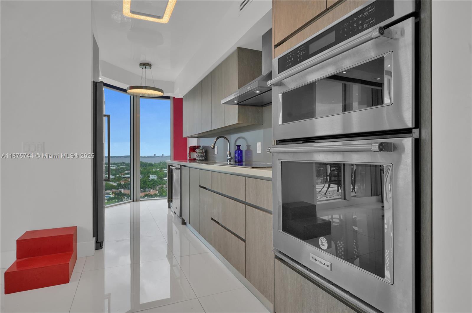 4779 Collins Avenue, Unit 1805 Miami Beach, FL 33140 - Photo 19 of 39 a kitchen view with stainless steel appliances granite countertop a stove and a refrigerator