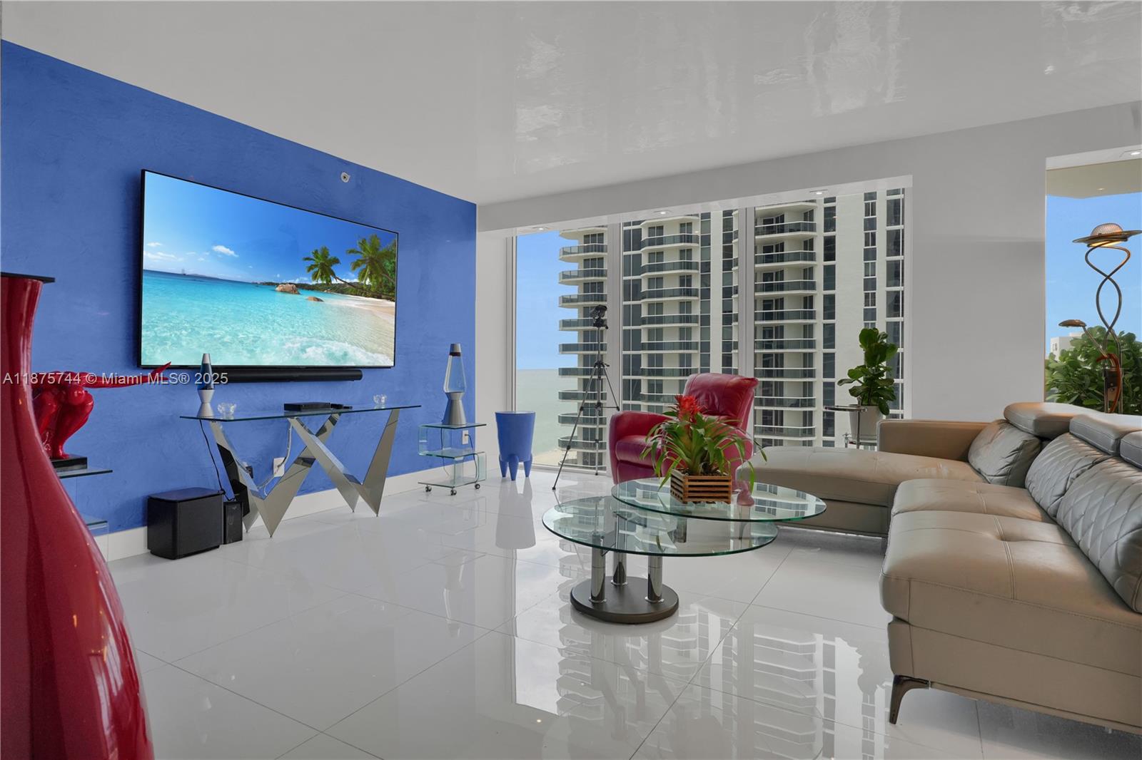 4779 Collins Avenue, Unit 1805 Miami Beach, FL 33140 - Photo 22 of 39 a living room with furniture and a flat screen tv