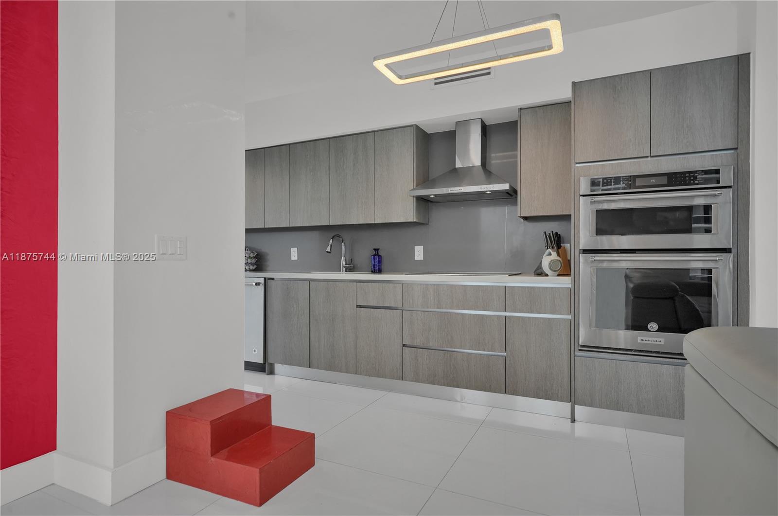 4779 Collins Avenue, Unit 1805 Miami Beach, FL 33140 - Photo 24 of 39 a kitchen with cabinets and oven