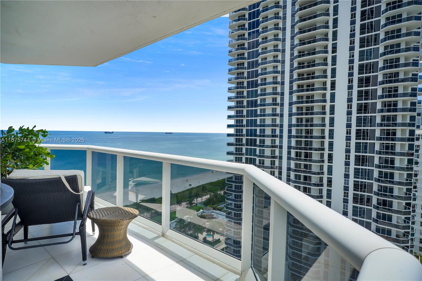 4779 Collins Avenue, Unit 1805 Miami Beach, FL 33140 - Photo 3 of 39 a balcony with table and chairs