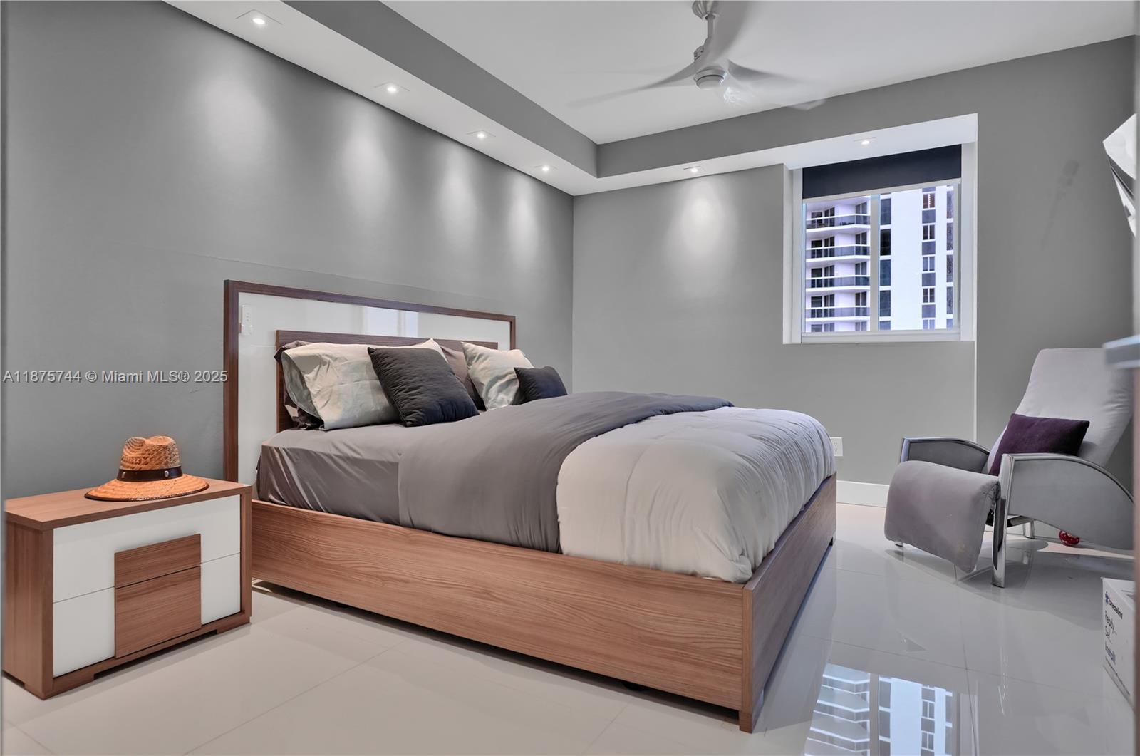 4779 Collins Avenue, Unit 1805 Miami Beach, FL 33140 - Photo 36 of 39 a bedroom with a bed and window