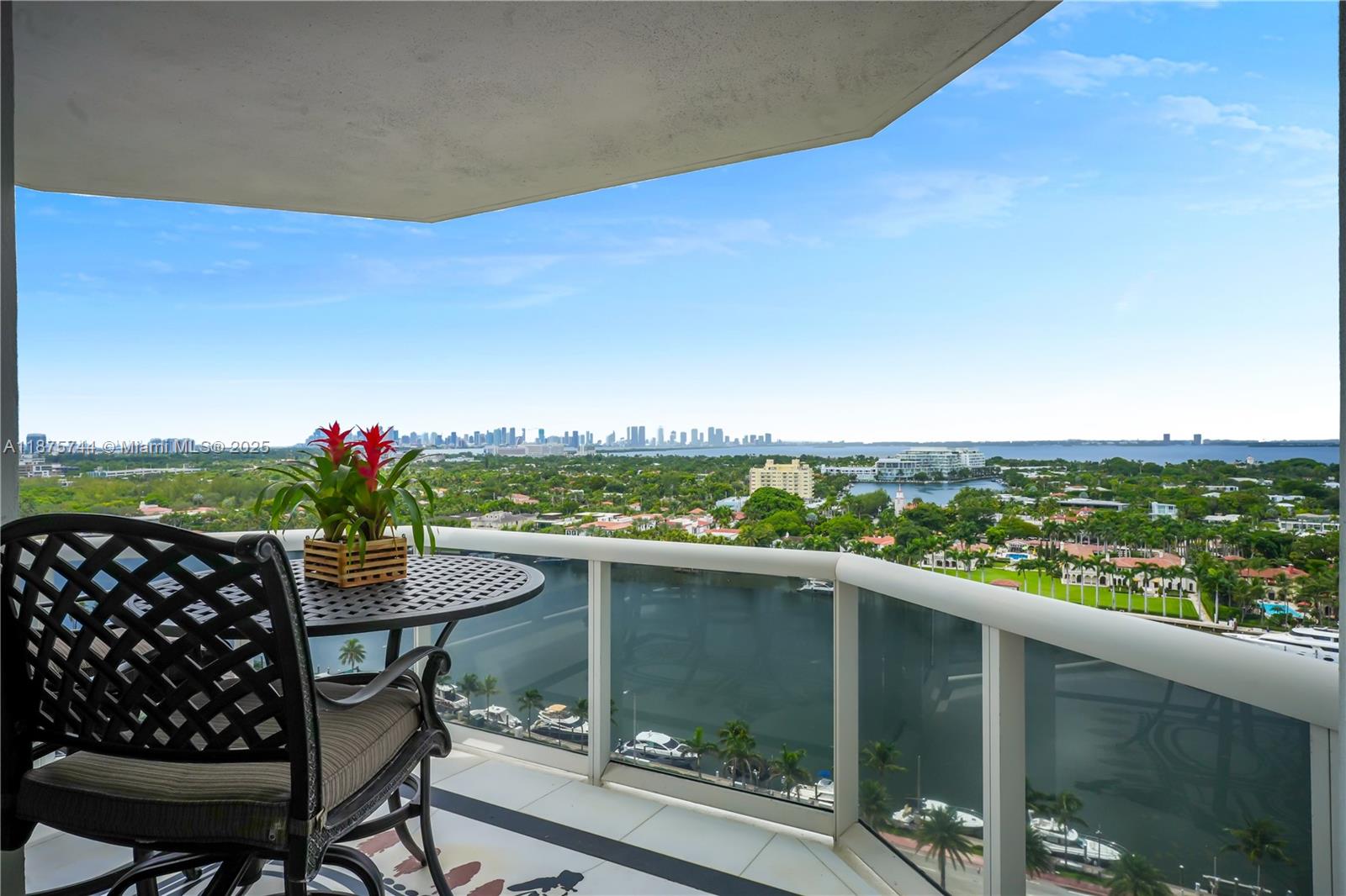 4779 Collins Avenue, Unit 1805 Miami Beach, FL 33140 - Photo 7 of 39 a view of a balcony with table and chairs and potted plants