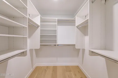 a large bathroom with a double vanity sink a toilet and a large mirror