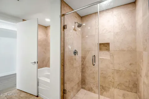 a view of an empty room with glass door and a window