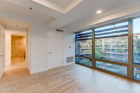a room with wine cabinets and a floor to ceiling window