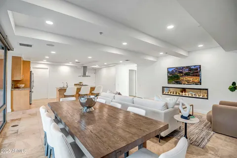 a living room with furniture a rug and a wall painting