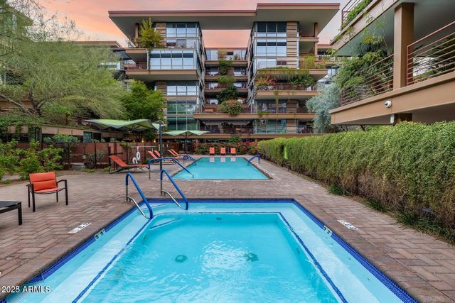 a view of kitchen with stainless steel appliances kitchen island wooden cabinets and fireplace