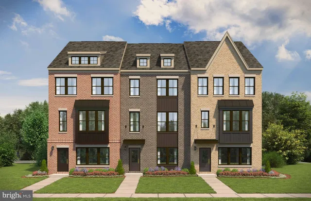 a front view of a residential apartment building with a yard