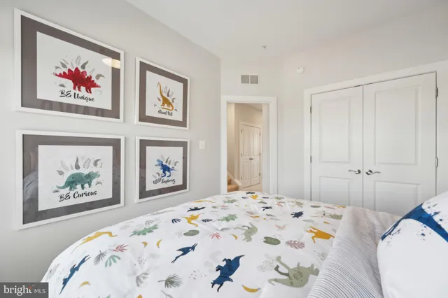 a bedroom with bed and painting on the wall