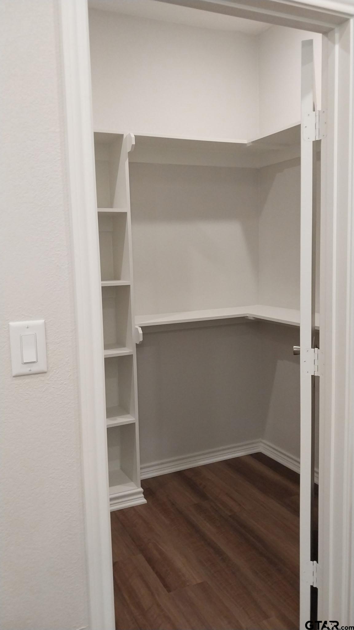 1262 George Richey Road Gladewater, TX 75647 - Photo 13 of 22 a view of walk in closet with empty racks