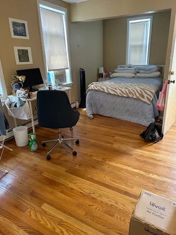 a bedroom with a bed a desk and chair