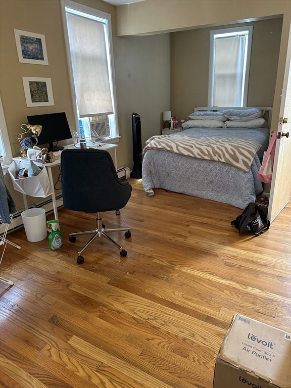 5 Lowden Avenue, Unit 2 Somerville, MA 02144 - Photo 13 of 20 a bedroom with a bed a desk and chair