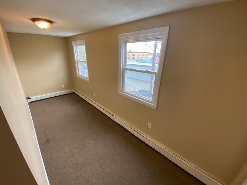 5 Lowden Avenue, Unit 2 Somerville, MA 02144 - Photo 15 of 20 an empty room with a window