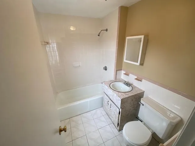 a bathroom with a sink a toilet and bathtub