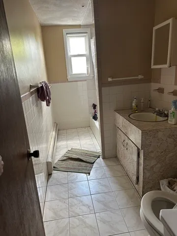 a bathroom with a sink a toilet and mirror