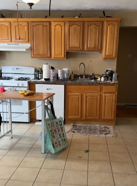 5 Lowden Avenue, Unit 2 Somerville, MA 02144 - Photo 4 of 20 a kitchen with stainless steel appliances granite countertop a sink and cabinets