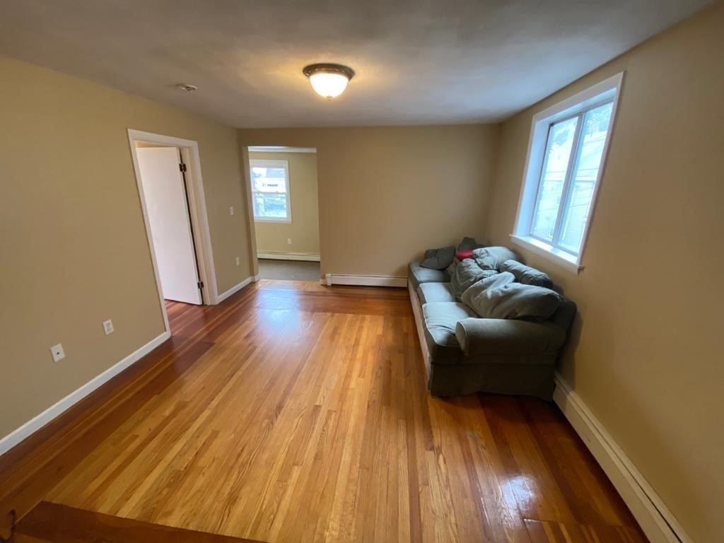5 Lowden Avenue, Unit 2 Somerville, MA 02144 - Photo 6 of 20 a living room with furniture and wooden floor