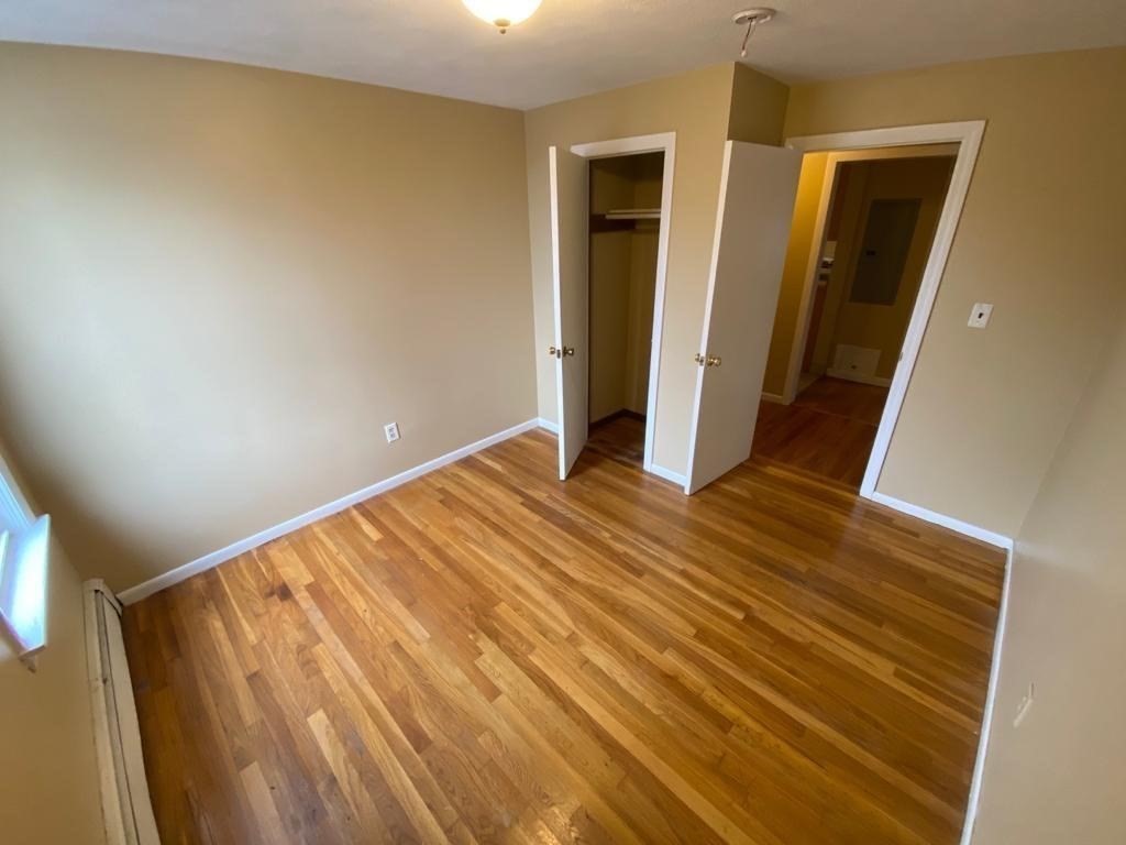 5 Lowden Avenue, Unit 2 Somerville, MA 02144 - Photo 9 of 20 a view of empty room with wooden floor