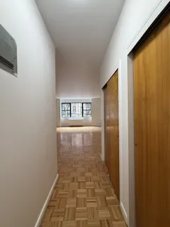 a view of a hallway with wooden floor