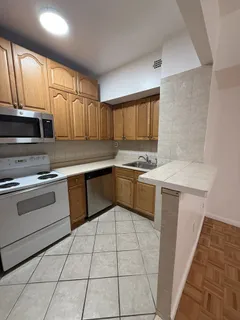a kitchen with a stove sink and cabinets