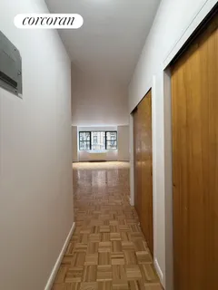 a view of a hallway with wooden floor