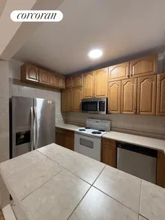 a kitchen with stainless steel appliances a refrigerator sink and cabinets