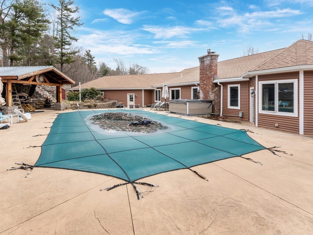 4 Thurston Hill Road Rutland, MA 01543 - Photo 28 of 35 a aerial view of a house with table and chairs under an umbrella
