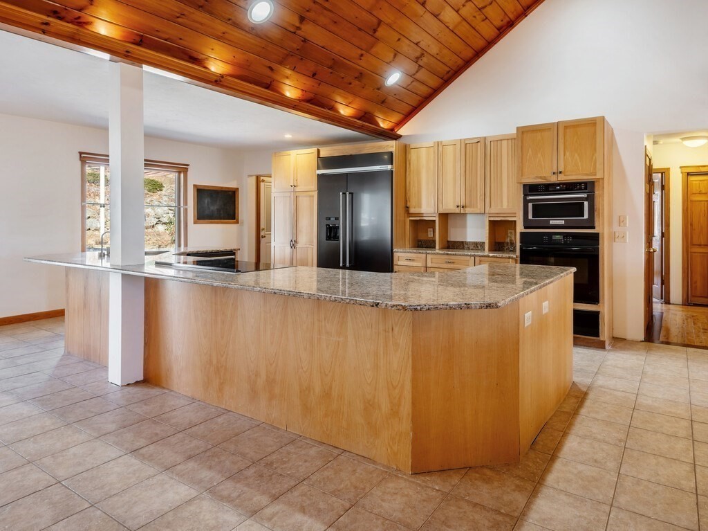 4 Thurston Hill Road Rutland, MA 01543 - Photo 9 of 35 a large kitchen with kitchen island granite countertop a large counter top stainless steel appliances and cabinets