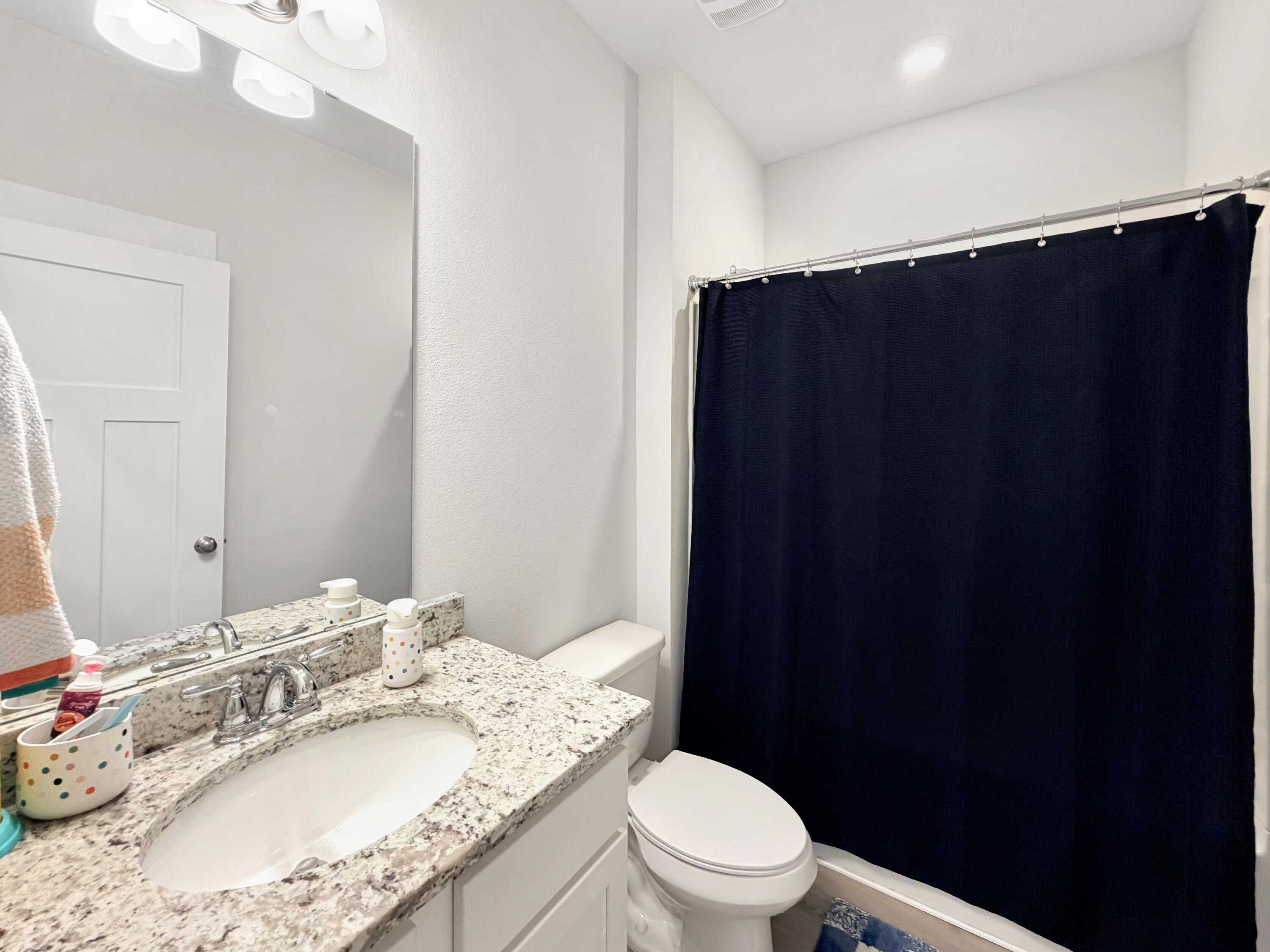 2456 Dakota Way Crestview, FL 32536 - Photo 19 of 38 a bathroom with a granite countertop sink vanity mirror and toilet
