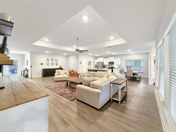 a living room with furniture white wooden floor and a fireplace