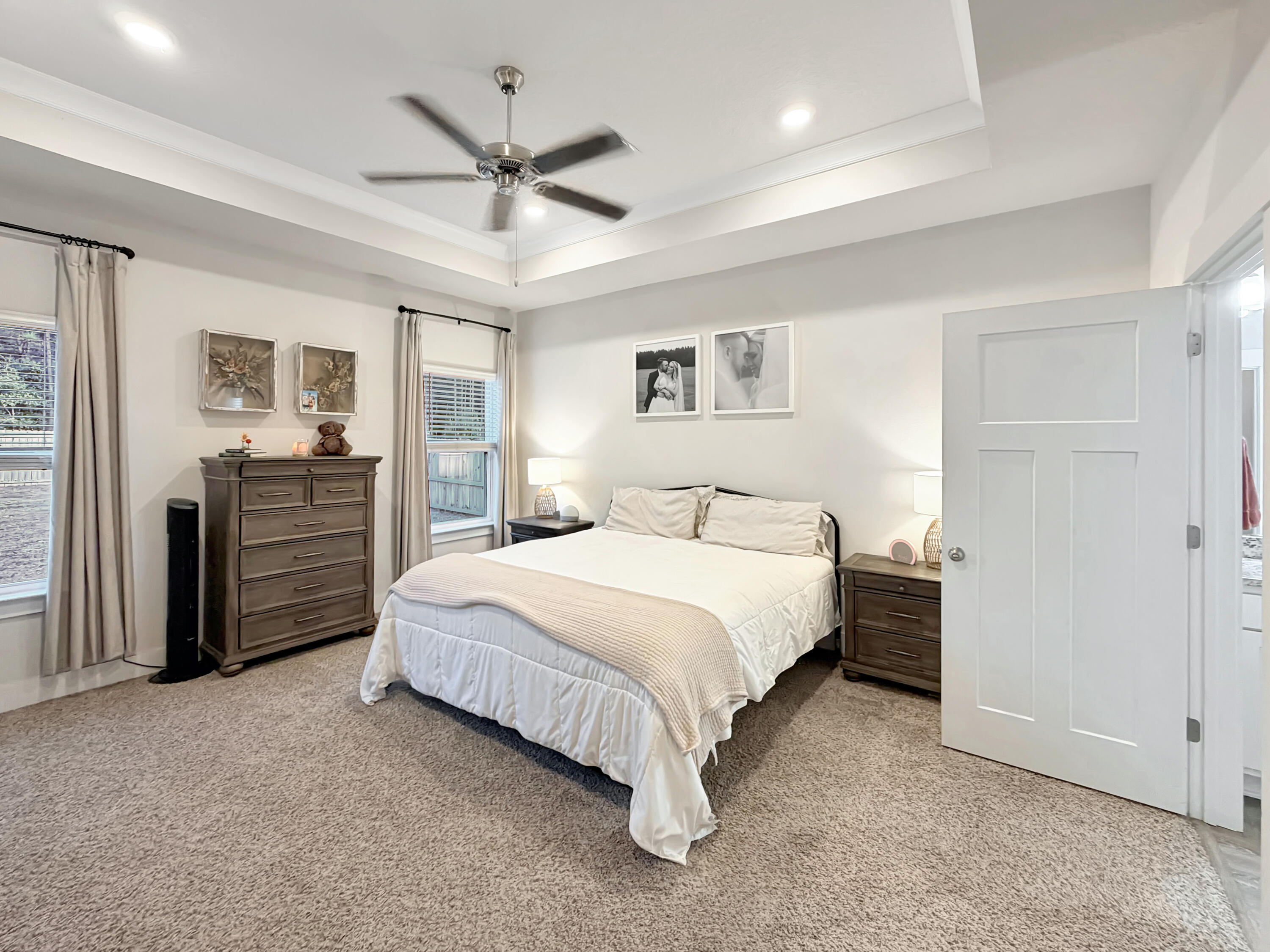 2456 Dakota Way Crestview, FL 32536 - Photo 22 of 38 a bedroom with a large bed a chandelier and closet