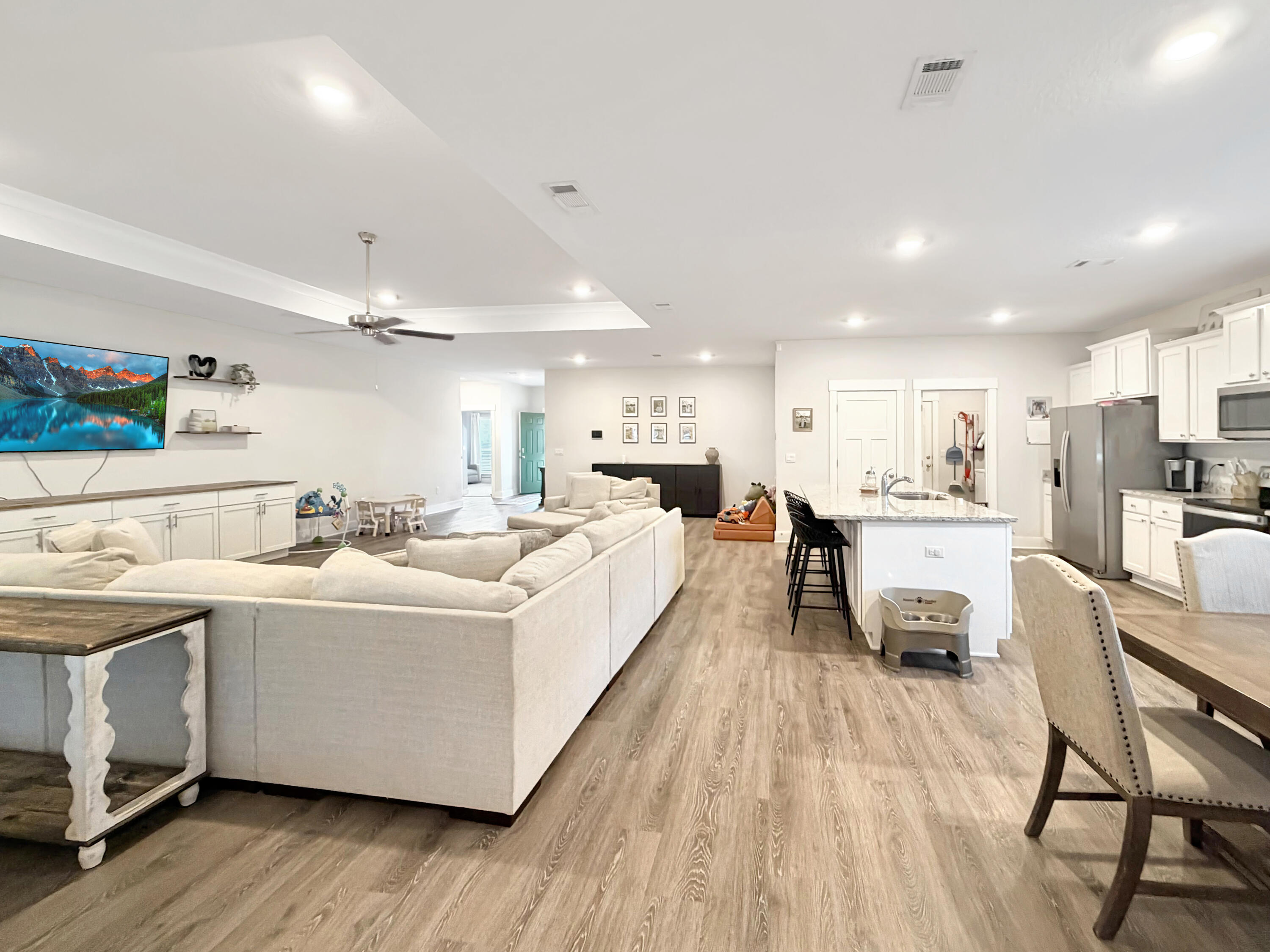 2456 Dakota Way Crestview, FL 32536 - Photo 23 of 38 a living room with stainless steel appliances kitchen island furniture and a wooden floor