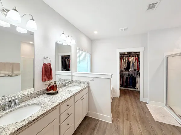 a spacious bathroom with a sink and a mirror