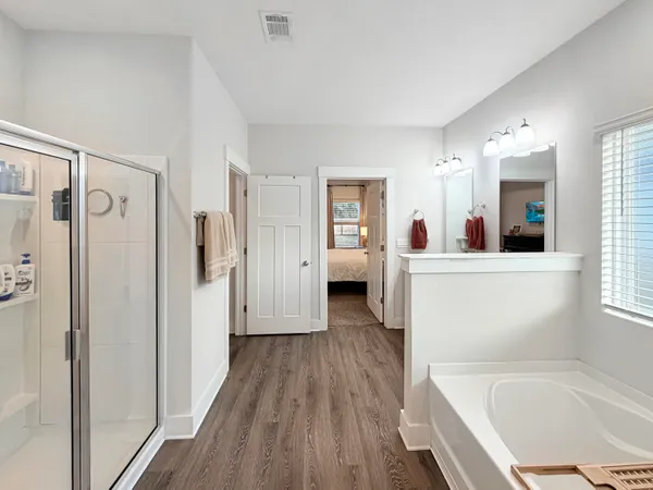 a kitchen with stainless steel appliances a refrigerator a stove a sink dishwasher with a dining table and chairs