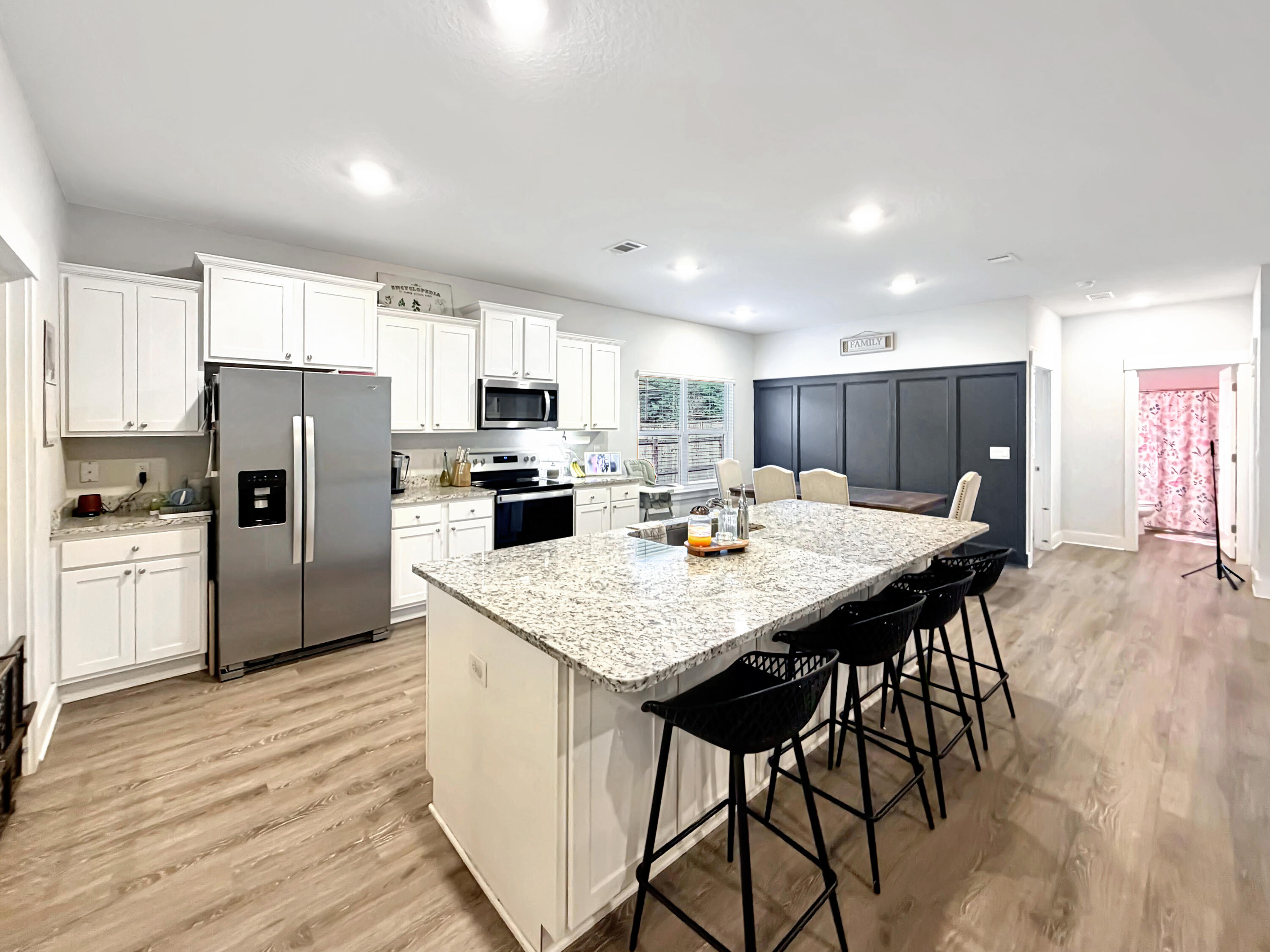 2456 Dakota Way Crestview, FL 32536 - Photo 9 of 38 a kitchen with stainless steel appliances a refrigerator a stove a sink dishwasher with a dining table and chairs