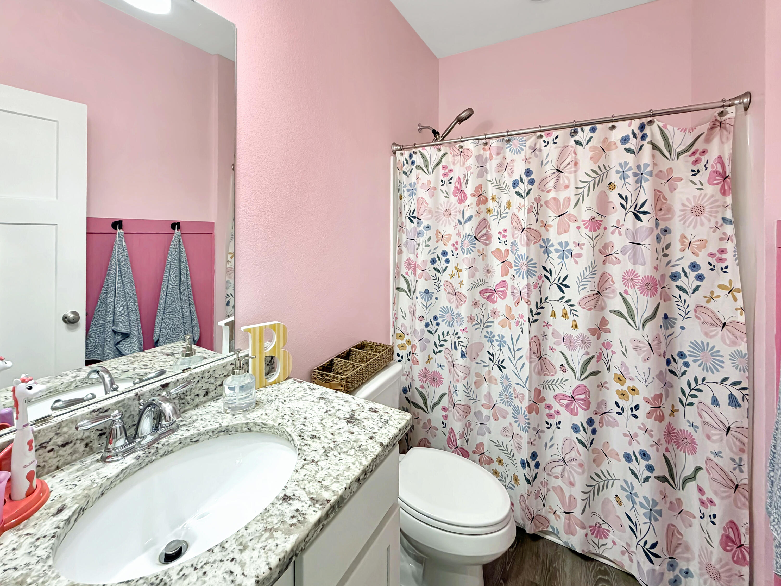 2456 Dakota Way Crestview, FL 32536 - Photo 10 of 38 a bathroom with a granite countertop sink a toilet and shower curtain